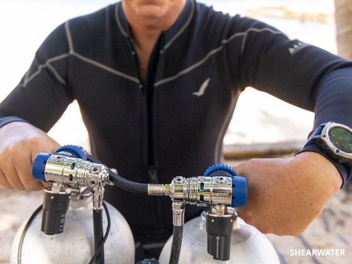 Diver opening a tank valve